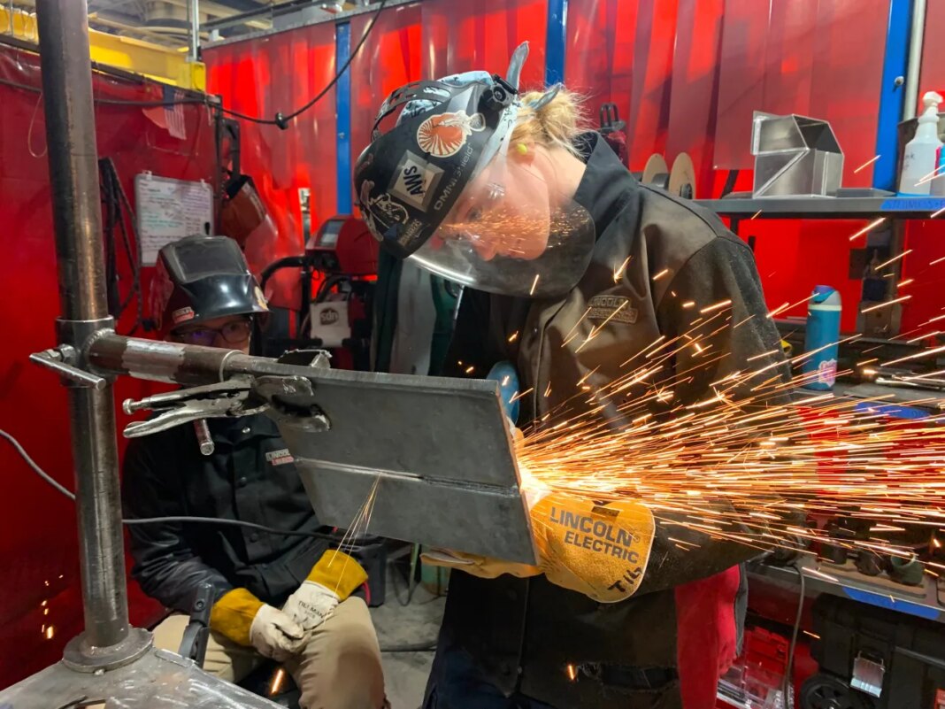 Student Mikala Sposito welds at Washtenaw Community College on Friday, May 1, 2026, in Ann Arbor., Mich. (AP Photo/Mike Householder)