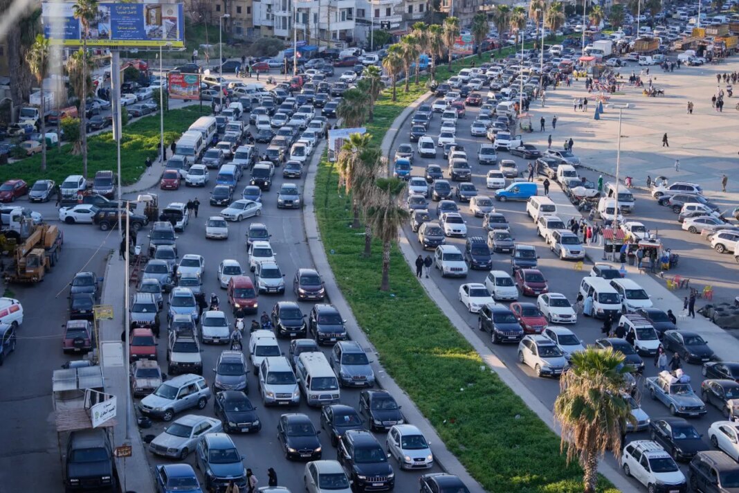 FILE - Displaced people fleeing Israeli strikes in southern Lebanon sit in traffic at a highway that links to Beirut, in the southern port city of Sidon, Monday, March 2, 2026. (AP Photo/Mohammed Zaatari, File)