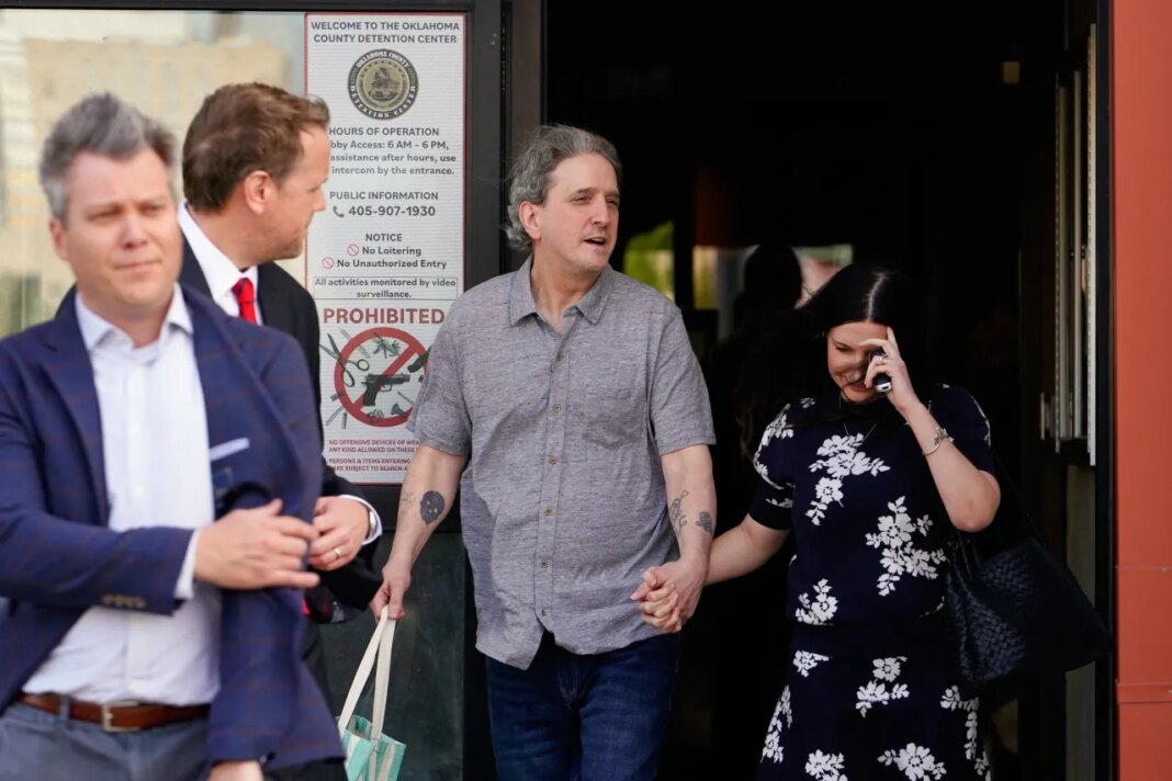 Former death row prisoner Richard Glossip, center, exits a detention facility alongside his wife Lea Glossip, right, after being granted bond while awaiting retrial Thursday, May 14, 2026, in Oklahoma City. (AP Photo/Nick Oxford)