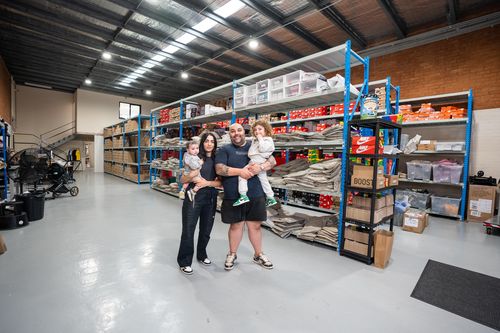 The Kozma family pose together inside one of the Waves Never Die warehouses.