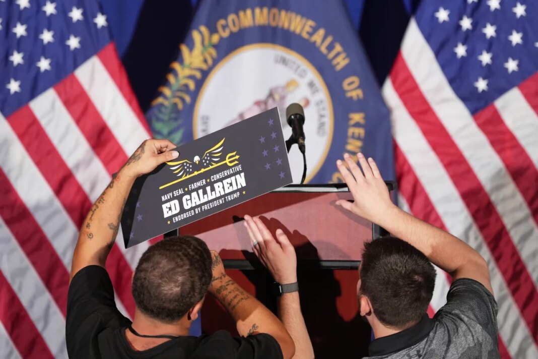 Workers attach a sign for Republican congressional candidate Ed Gallrein before he speaks at an election night event Tuesday, May 19, 2026, in Covington, Ky. (AP Photo/Joshua A. Bickel)