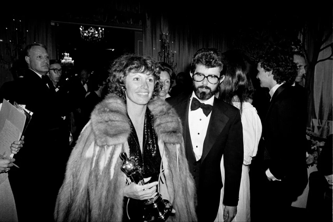 FILE - Marcia Lucas, wife of director George Lucas, right, carries her Oscar statuette as they arrive at a post Academy Awards party at the Beverly Hilton Hotel in Los Angeles, April 4, 1978. (AP Photo, File)