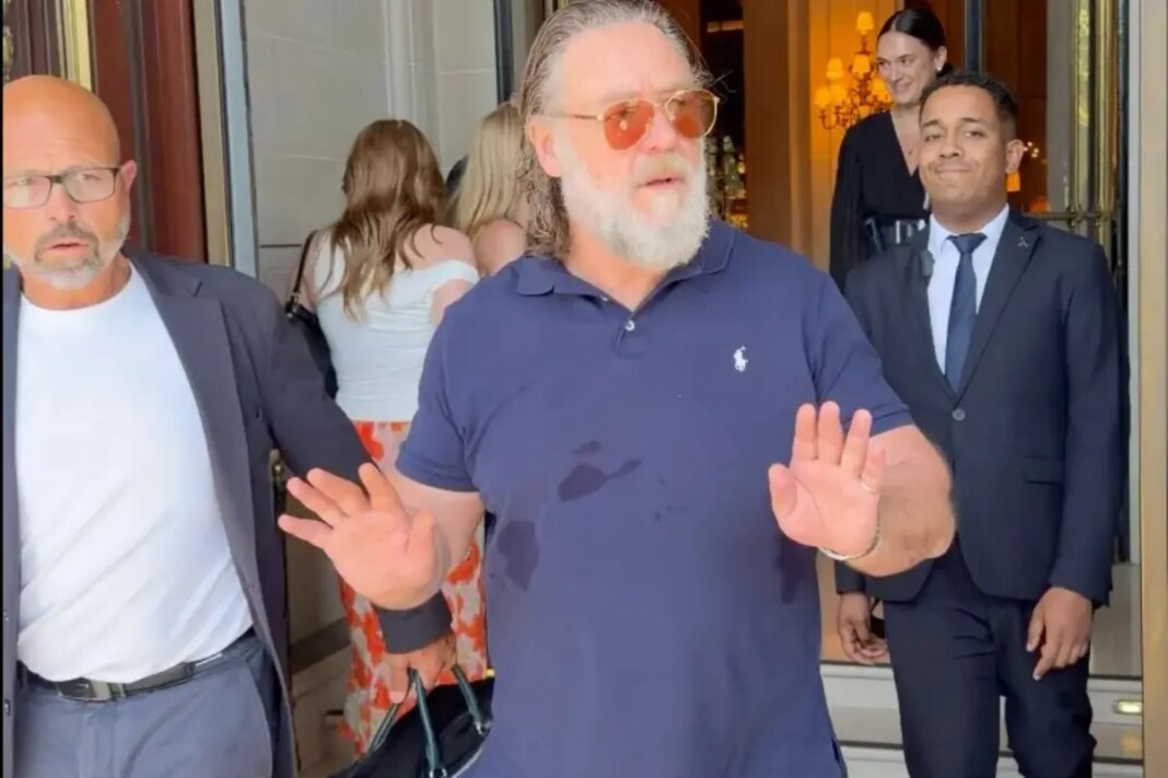 Russell Crowe warns autograph hunters gathered outside his Paris hotel: 'Don't f--king push in on me'