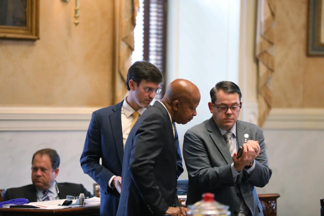 Republican South Carolina Sen. Carlisle Kennedy, left, Democratic Sen. Ronnie Sabb, middle, and Republican Sen. Jeff Zell, right, watch a video during a session on redistricting on Tuesday, May 26, 2026, in Columbia, S.C. (AP Photo/Jeffrey Collins)