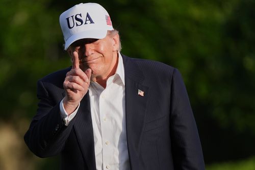 President Donald Trump gestures to reporters as he walks across the South Lawn of the White House, Friday, May 15, 2026.