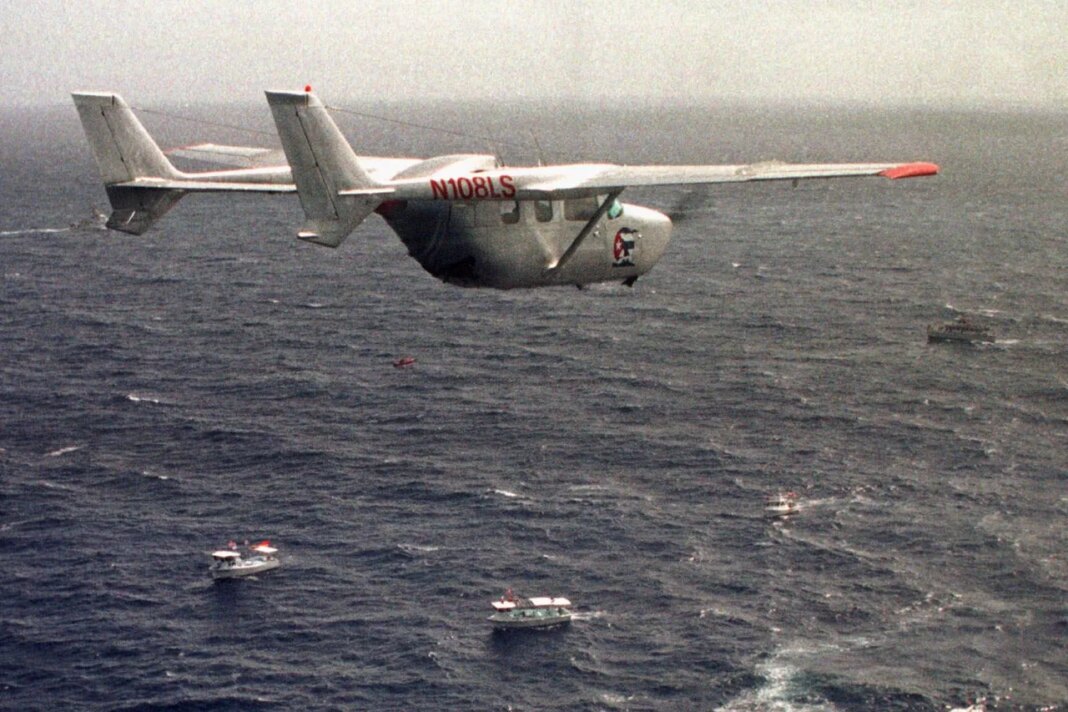 FILE - A Brothers to the Rescue plane flies over The Democracy Movement flotilla at the twelve-mile limit north of Havana, Cuba, July 10, 1999. (AP Photo/Alan Diaz, File)