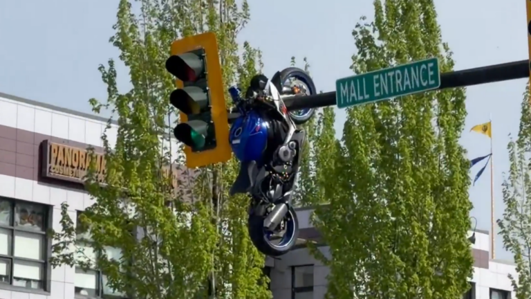 Watch: Shocking Moment Motorcycle Dangles from Traffic Light Post-Collision
