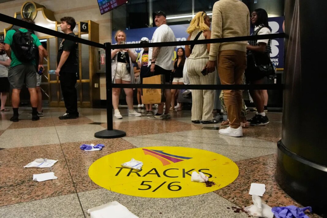 People stand near an area roped off after a stabbing at Penn Station on Sunday, June 7, 2026, in New York. (AP Photo/Ross D. Franklin)