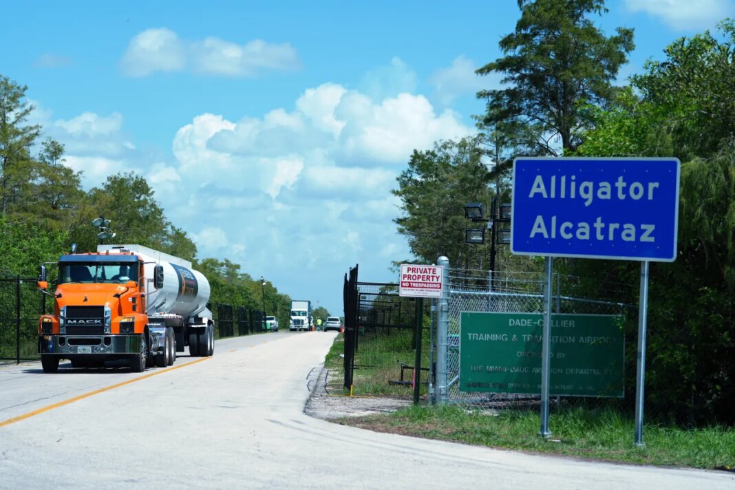 FILE - Trucks come and go from the 
