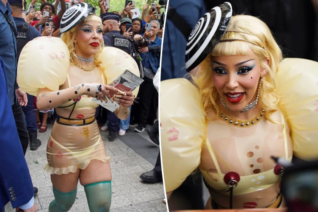 Doja Cat’s sheer latex look has faux piercings, inflated sleeves and lipstick kisses