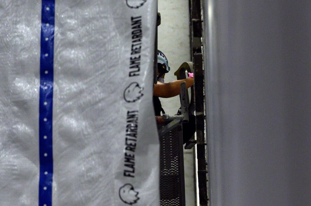 A worker removes a letter from President Donald Trump