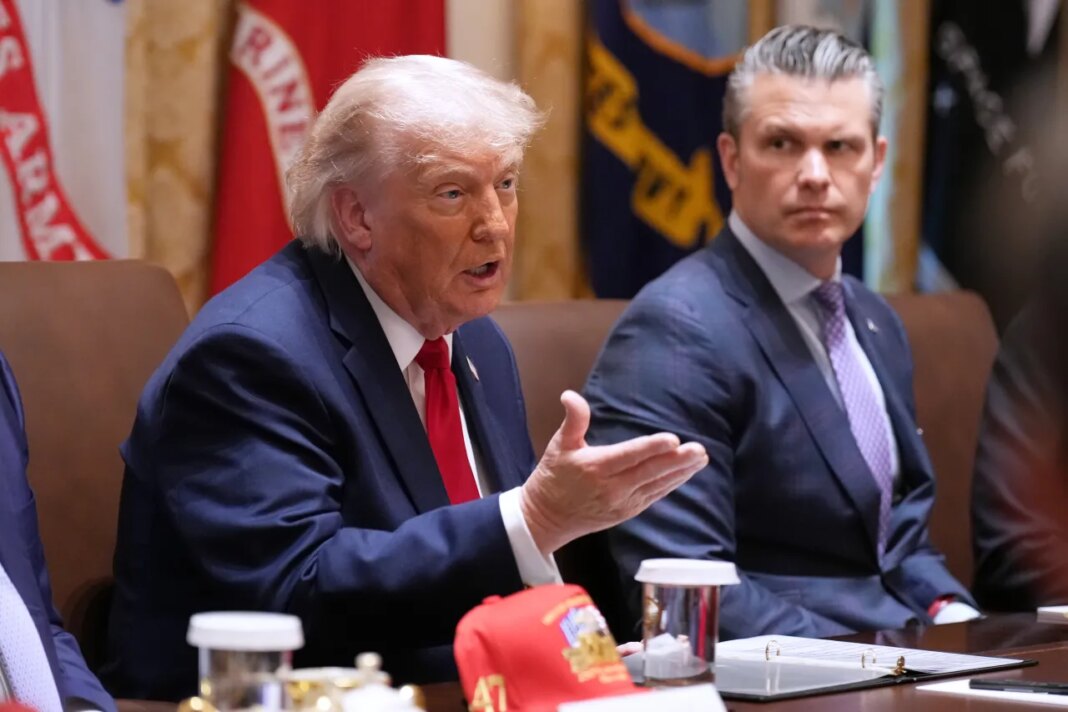 President Donald Trump speaks during a Cabinet meeting at the White House, Wednesday, May 27, 2026, in Washington, as Secretary of Defense Pete Hegseth, looks on. (AP Photo/Jacquelyn Martin)