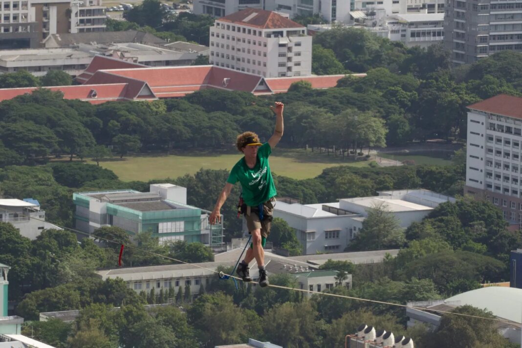 FILE - U.S. slackliner Andy Lewis of Calif. balances on a slackline in Bangkok, Thailand, July 23, 2014. (AP Photo/Sakchai Lalit, File)