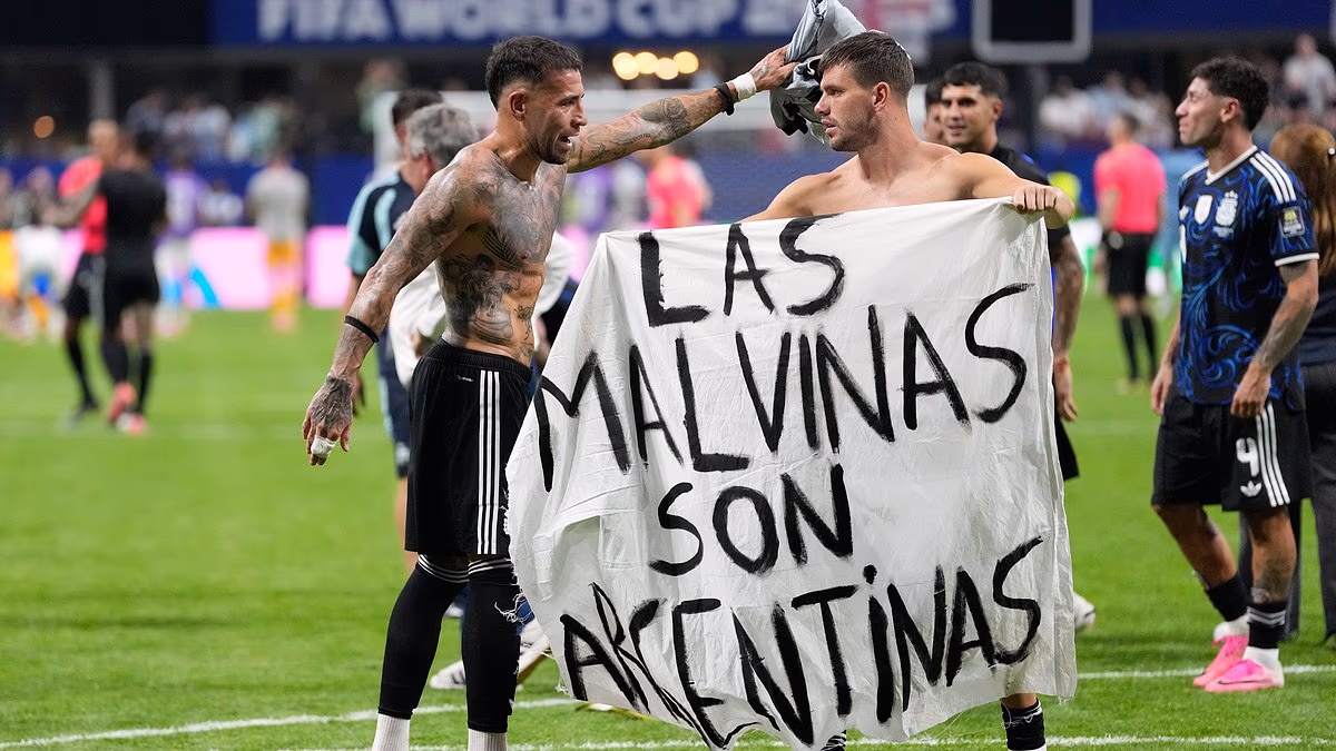 Argentina players hold banner claiming the Falkland Islands after knocking England out of the World Cup
