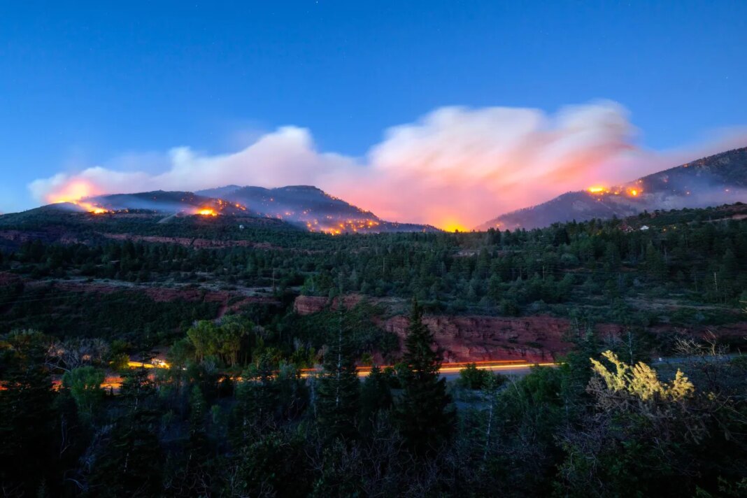 Firefighters drive along Highway 550 as they try to access the Gold Mountain Fire on the town line of Ouray and Ridgeway, Colo., on Sunday, June 28, 2026. (Michael Seamans/The Gazette via AP)