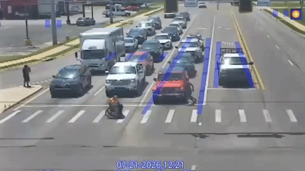 Good Samaritan in Spider-Man costume helps man in wheelchair cross busy intersection in viral moment