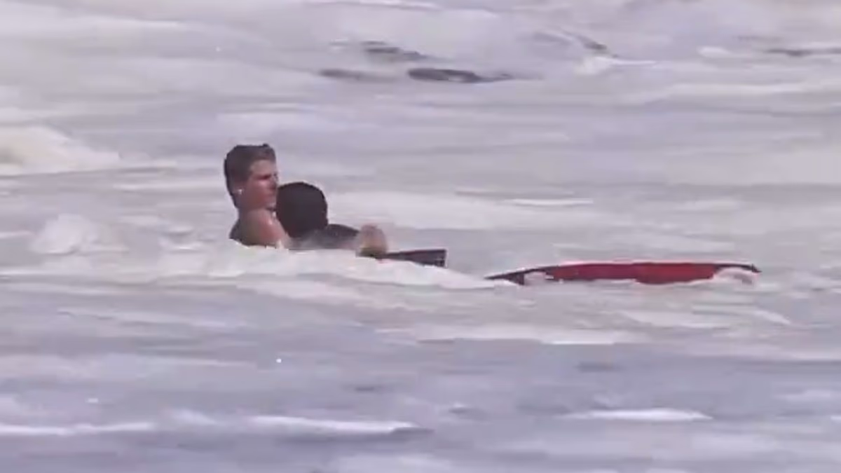 Hero lifeguard aged just SIXTEEN is filmed rescuing child from ocean