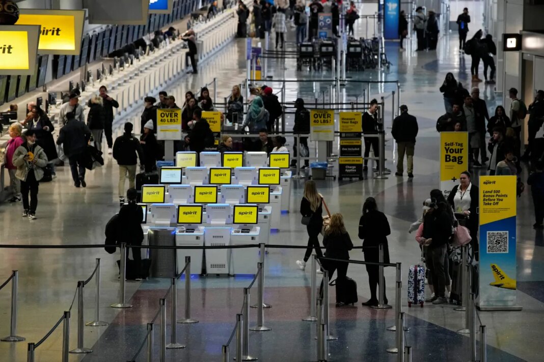 FILE - People check into their flights at Harry Reid International Airport, Jan. 11, 2023, in Las Vegas. (AP Photo/John Locher, File)
