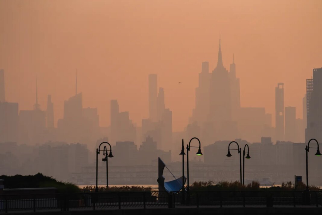 The New York City skyline is seen through a cover of wildfire smoke, in Jersey City, N.J., Friday, July 17, 2026. (AP Photo/Ryan Murphy)