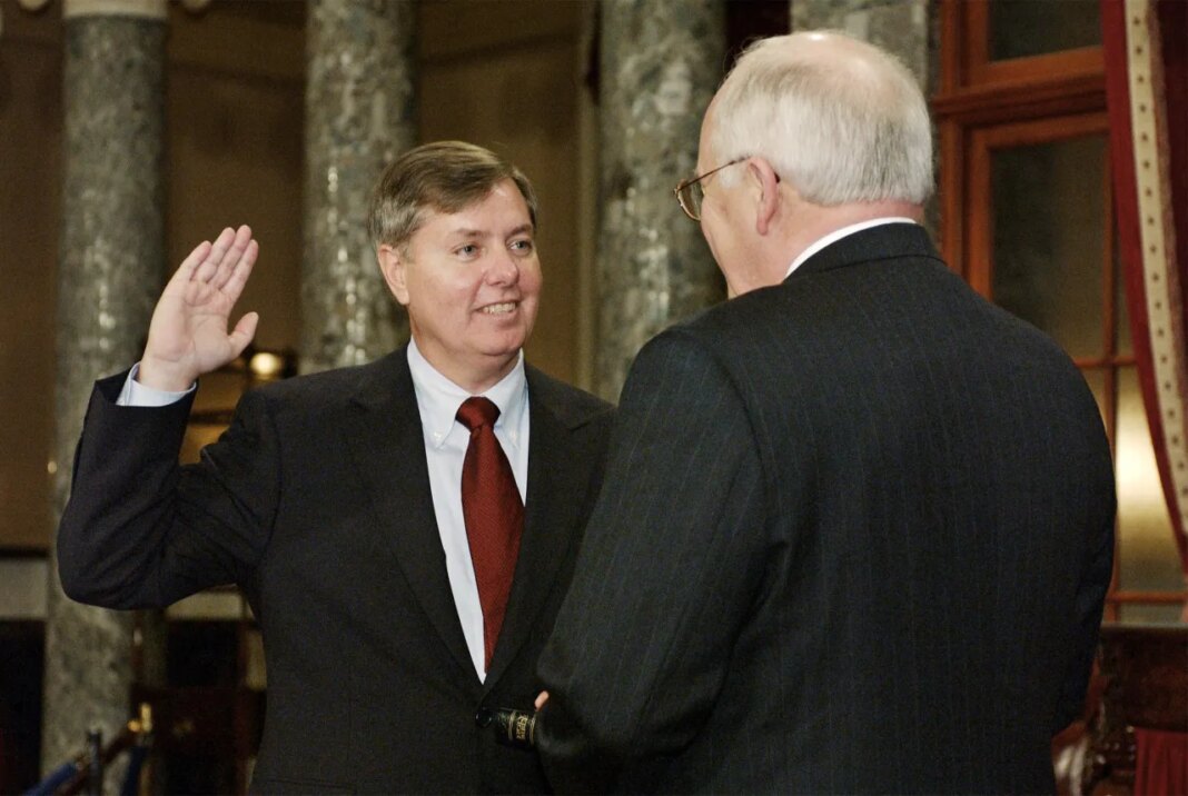 FILE - Sen. Lindsey Graham, R-S.C., takes the oath of office with Vice President Dick Cheney, right, during a re-enactment swearing-in ceremony in the Old Senate Chamber on Capitol Hill in Washington, Jan. 7, 2003, following his election to the Senate. (AP Photos/Evan Vucci, File)