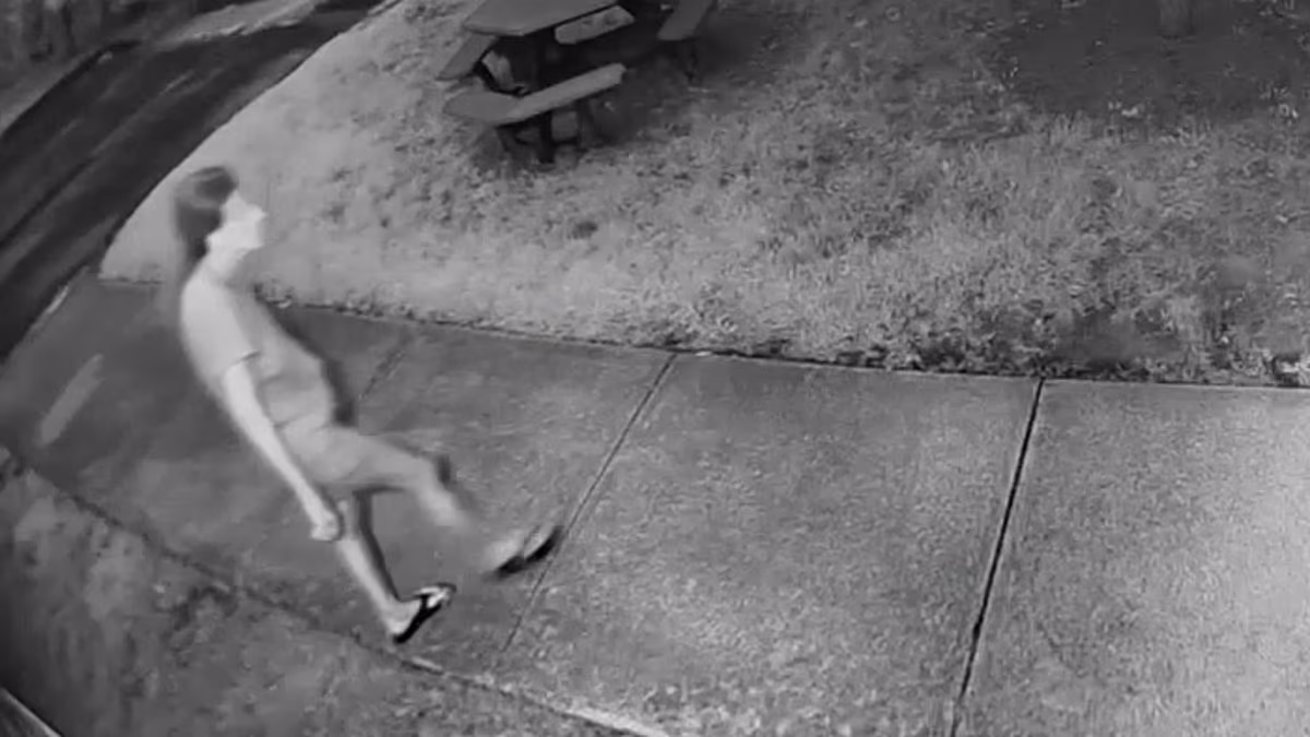 Fugitive wife in flip flops struts down road after husband's murder