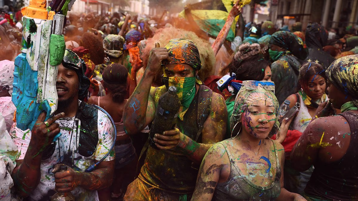 Notting Hill Carnival starts as revellers douse each other with paint