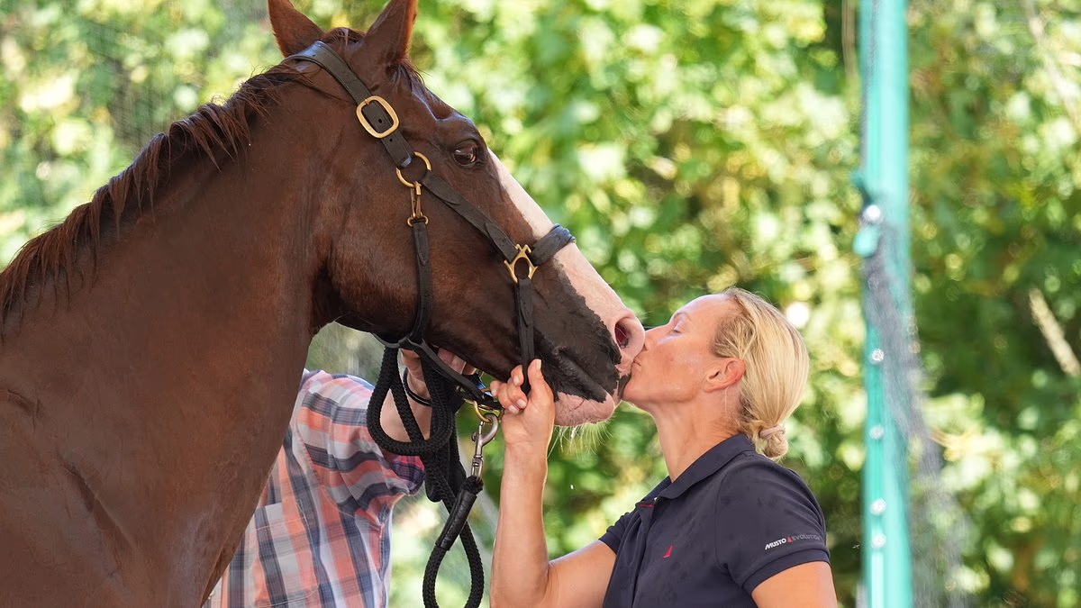 Sealed with a kiss: Zara Tindall beams and jumps for joy after winning first major championship in nearly 20 years at the British Open Championships