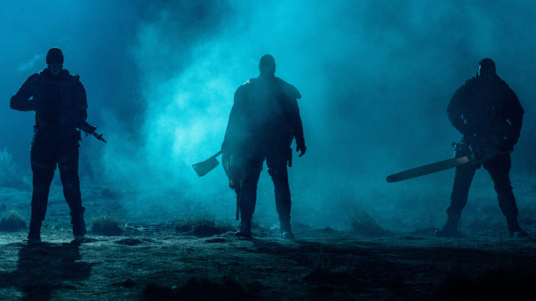 Cockroach, Butcher, and Crybaby standing ominously at night, weapons out, in 