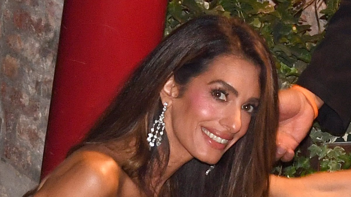 Amal Clooney needs a helping hand to exit her boat in Venice