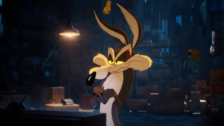 Wile E. Coyote at a desk smirking in Coyote vs. Acme