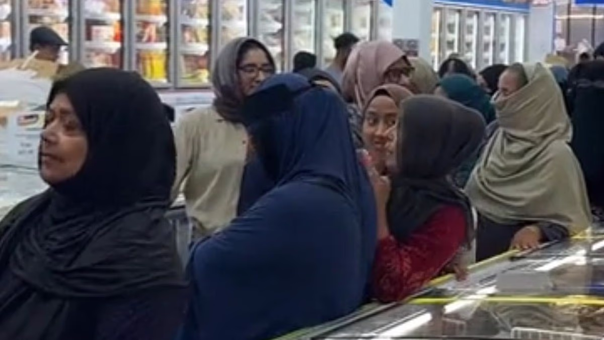 Customers at Asian supermarket in London form male and female queues