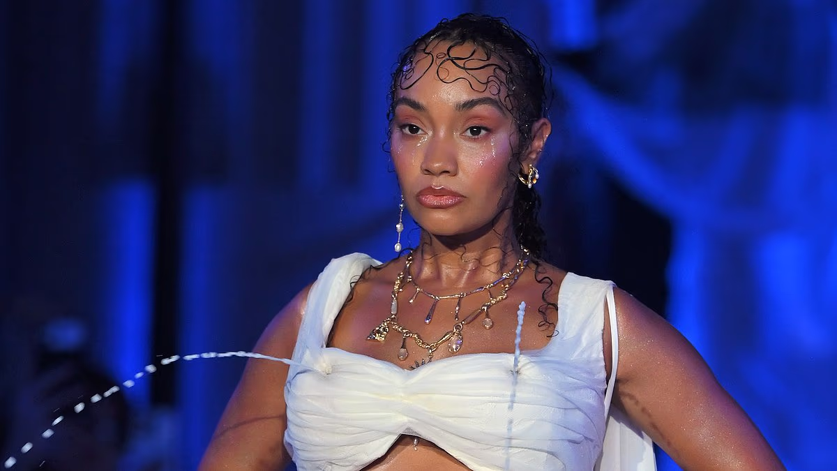 Pregnant Leigh-Anne Pinnock bares her baby bump and draws audible gasps from the crowd as her body becomes a fountain at the Di Petsa London Fashion Week show
