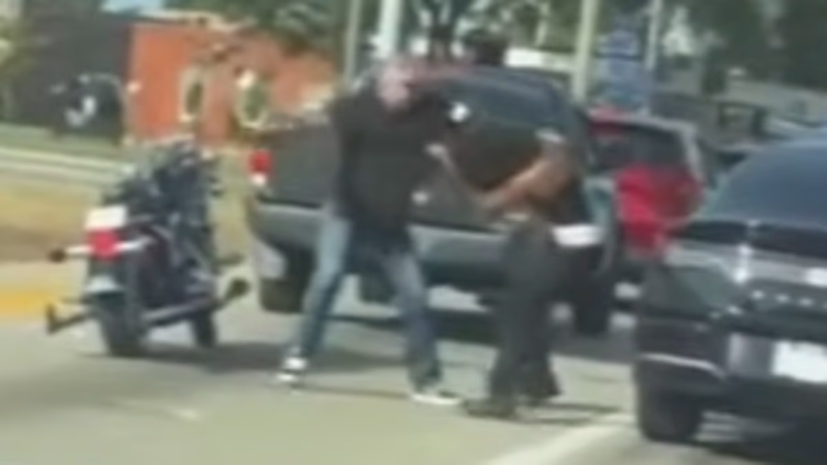 A white man filmed beating a black woman with a belt
