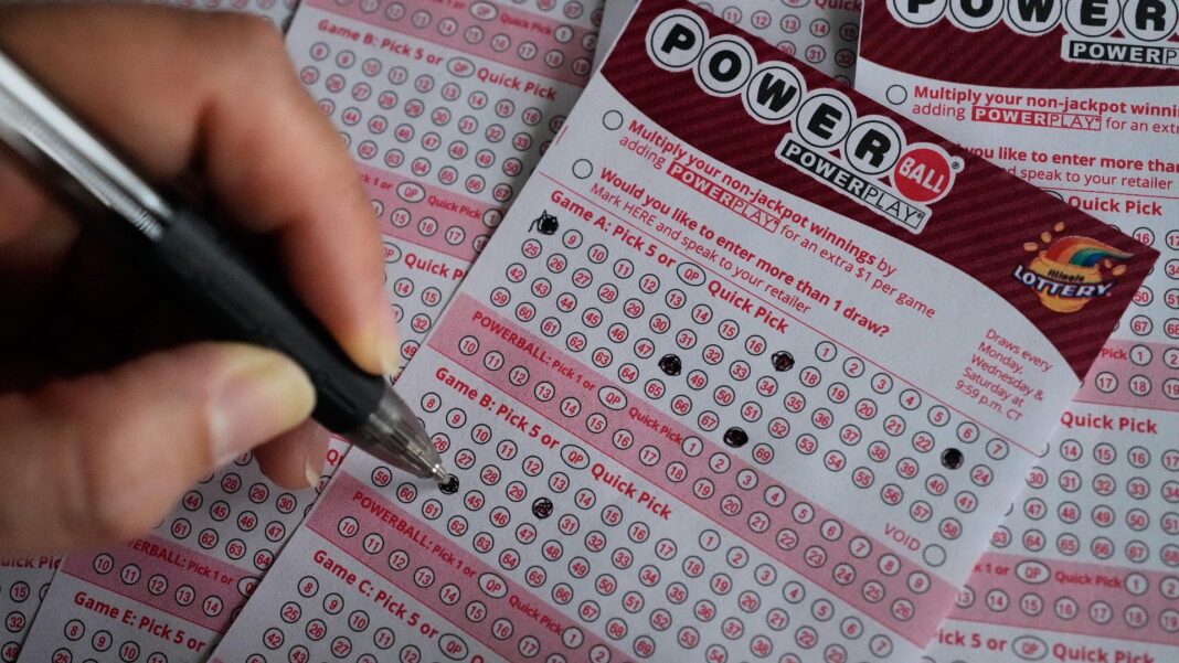 A customer fills out a Powerball lottery ticket at a convenience store in Mundelein, Ill., Monday, Dec. 15, 2025.