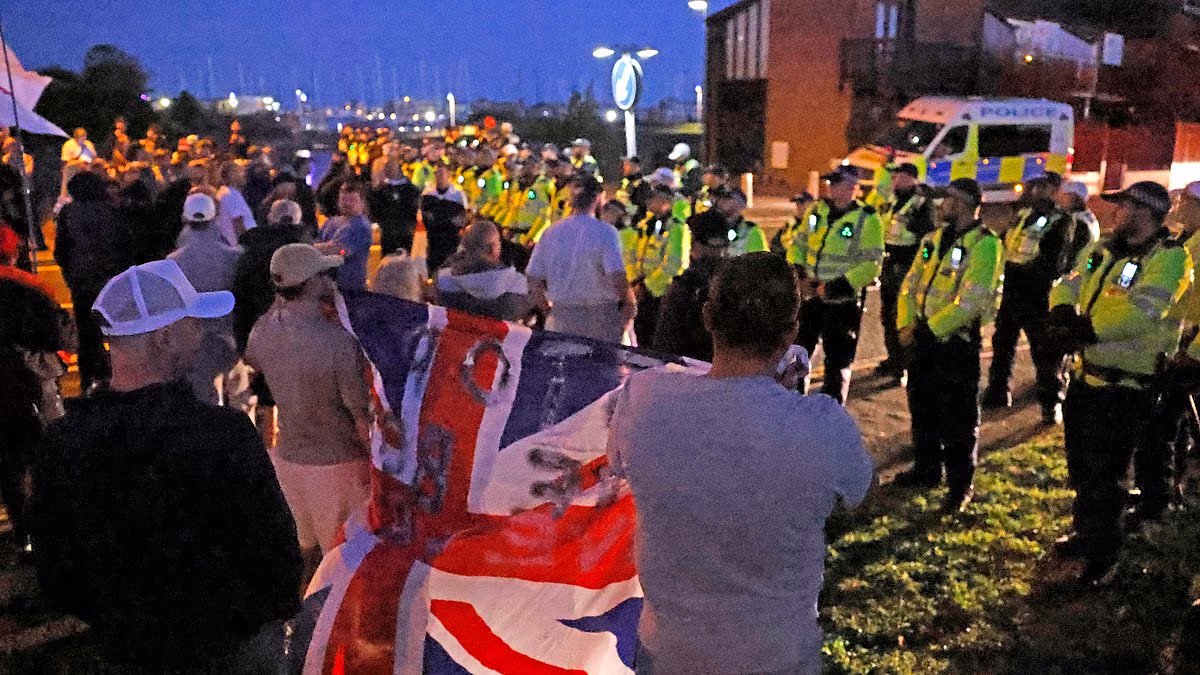 Protesters scuffle with police after migrants land on south coast