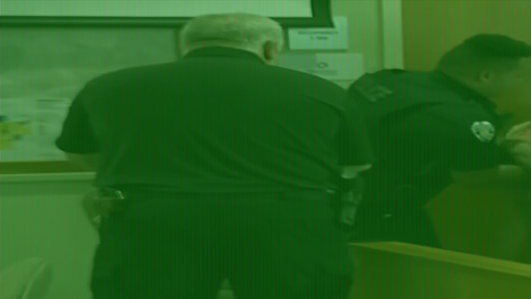 Suspect carried into court with pants down on charges of murdering dad