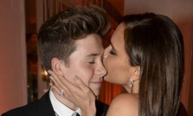 Victoria Beckham dazzles in a plunging black gown with son Brooklyn